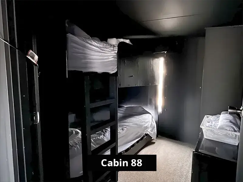 Cabin 88’s second bedroom with two sets of bunk beds and soft lighting, ideal for families or group stays.