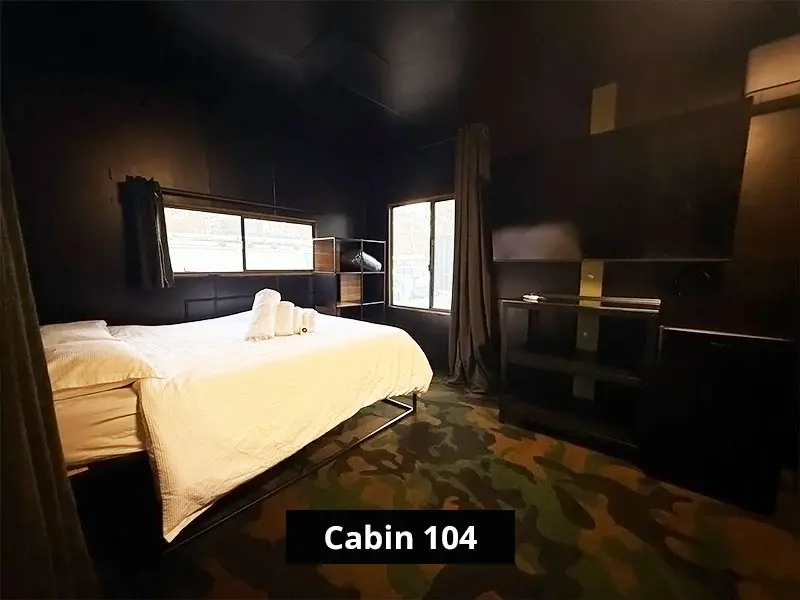 Queen bed inside Cabin 104 at C&V Parks Stawell, providing comfortable and affordable accommodation in Stawell near the Grampians.
